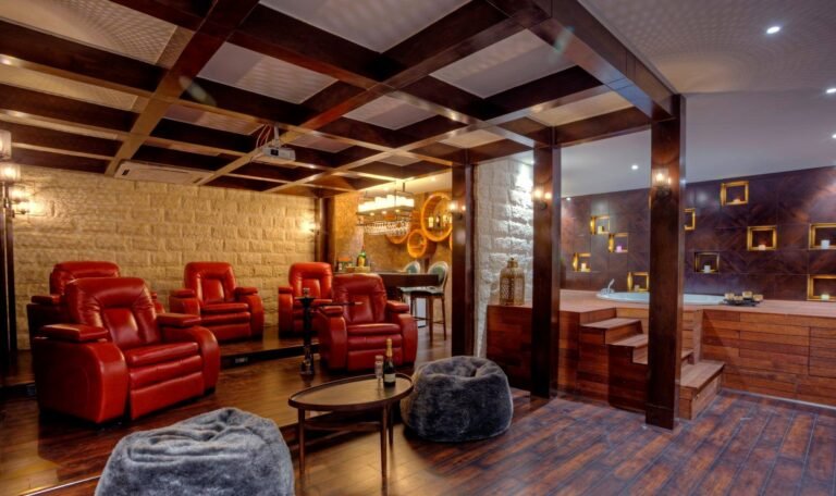 Luxurious home theater with red leather seats and a jacuzzi on the right.