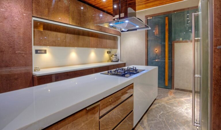 Modern kitchen interior with wood finishes, white countertop, and built-in gas stove.