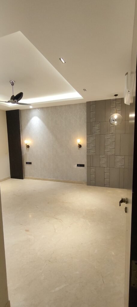 Minimalist bedroom interior with designer false ceiling, modern wall sconces, textured wall paneling, and marble flooring.