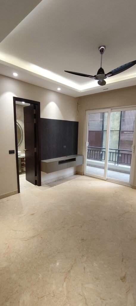 Modern bedroom interior with subtle wall textures, geometric paneling, designer ceiling fan, and ambient lighting.